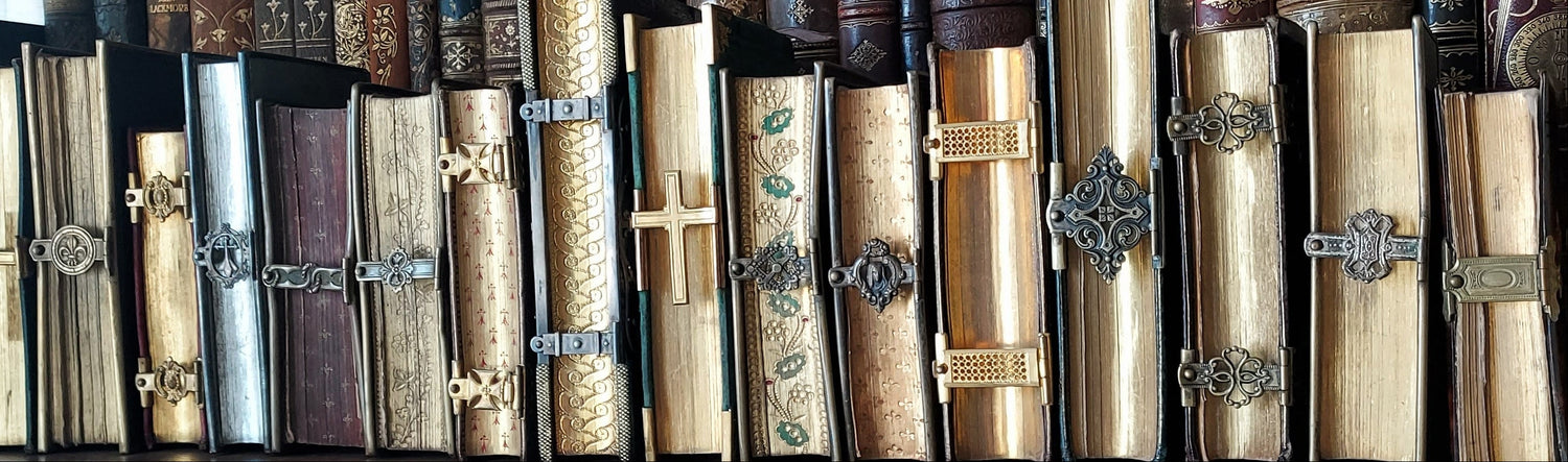 A collection of 19th-century antique prayer books with metal clasp closures. 